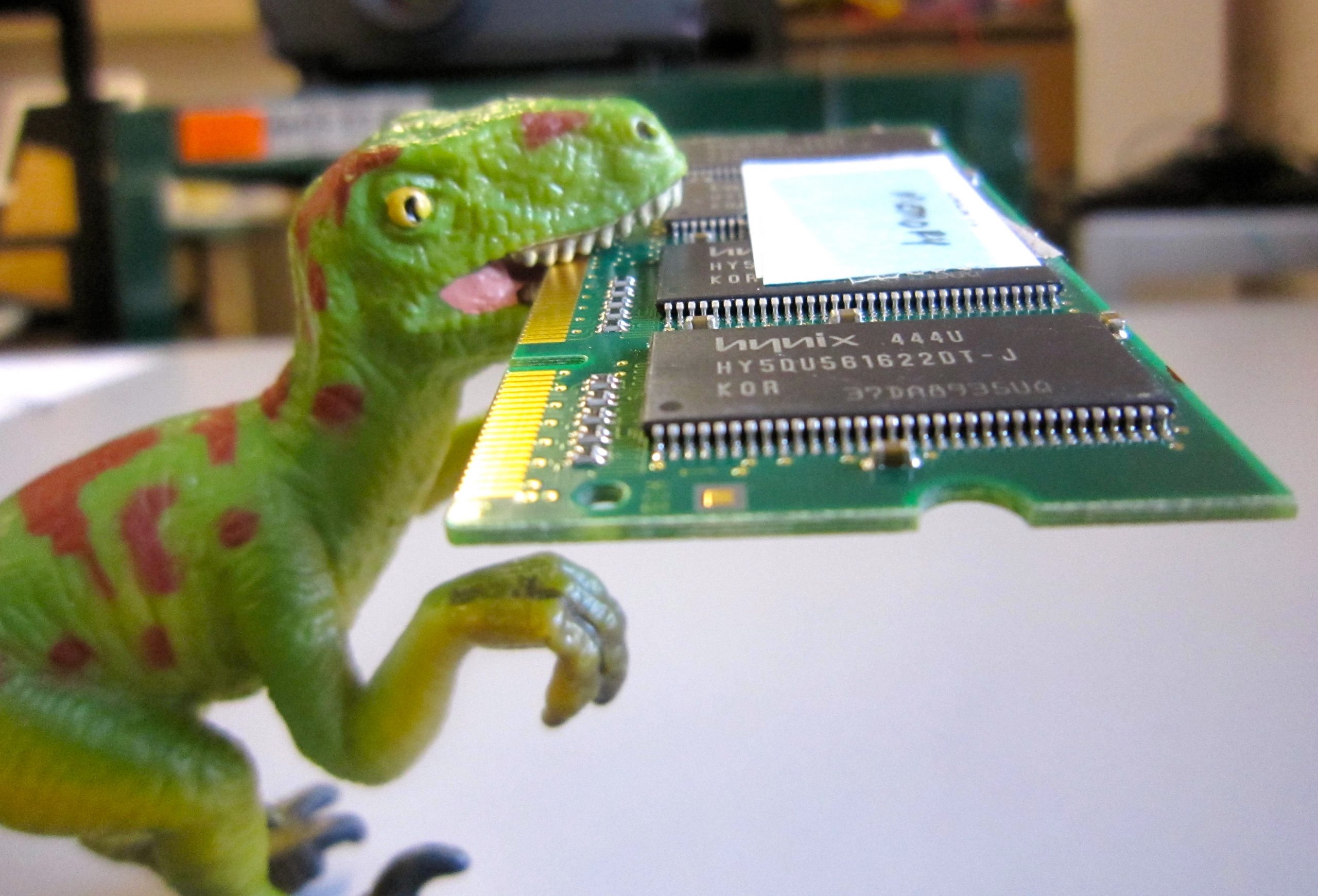 Toy dinosaur eating a computer chip