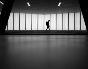 Person walking alone down a hallway
