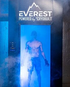 Man standing inside an electric , whole-body cryotherapy chamber.