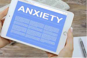 This image depicts an individual researching and taking notes about anxiety.